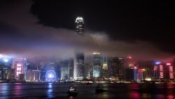 The IFC tower is seen shrouded in smoke after fireworks were fired over the city skyline as part of China's national day celebrations in Hong Kong on October 1, 2015. China is marking the 66th anniversary of the founding of the People's Republic of China on October 1, 1949.  AFP PHOTO / Philippe Lopez        (Photo credit should read PHILIPPE LOPEZ/AFP/Getty Images)