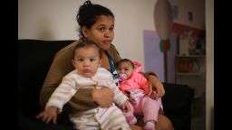 Jacqueline Silva de Oliveira with her twins, Lucas and Laura.