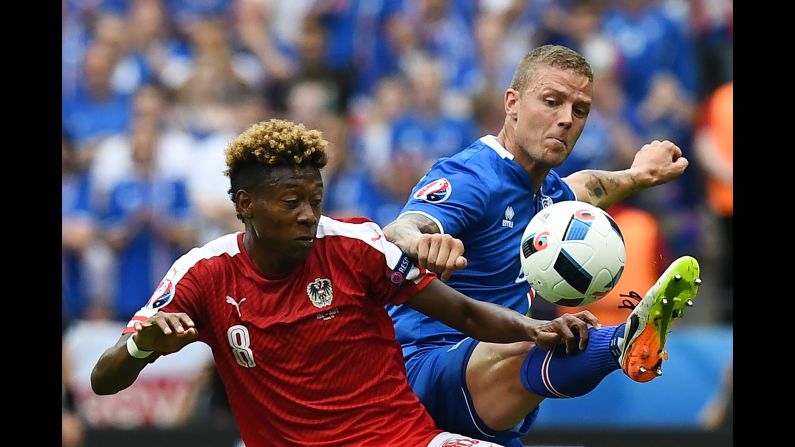Austrian midfielder David Alaba competes against Icelandic defender Ragnar Sigurdsson.