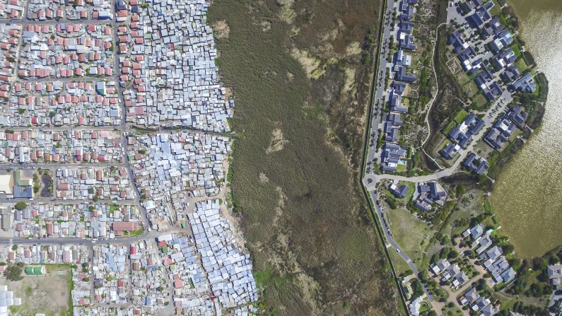 Pictured are the neighboring areas of Masiphumelele and Lake Michelle. Although Masiphumelele was not set up during apartheid, it is a former township. <br />"Black people lived in these areas usually fenced off or somehow separated from other areas through buffer zones such as highways, green belts, train tracks or rivers," notes Miller.