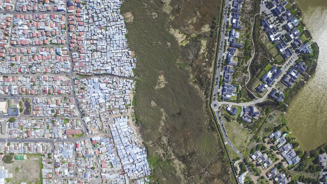 Pictured are the neighboring areas of Masiphumelele and Lake Michelle. Although Masiphumelele was not set up during apartheid, it is a former township. <br />"Black people lived in these areas usually fenced off or somehow separated from other areas through buffer zones such as highways, green belts, train tracks or rivers," notes Miller.