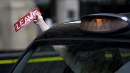 A taxi driver holds a sticker for the "Vote Leave" pro-Brexit campaign as he drives past media in central London on June 22, 2016, ahead of the June 23 EU referendum.
Rival sides threw their efforts into the final day of campaigning Wednesday, on the eve of Britain's vote on EU membership that will shape the future of Europe.
 / AFP / JUSTIN TALLIS        (Photo credit should read JUSTIN TALLIS/AFP/Getty Images)