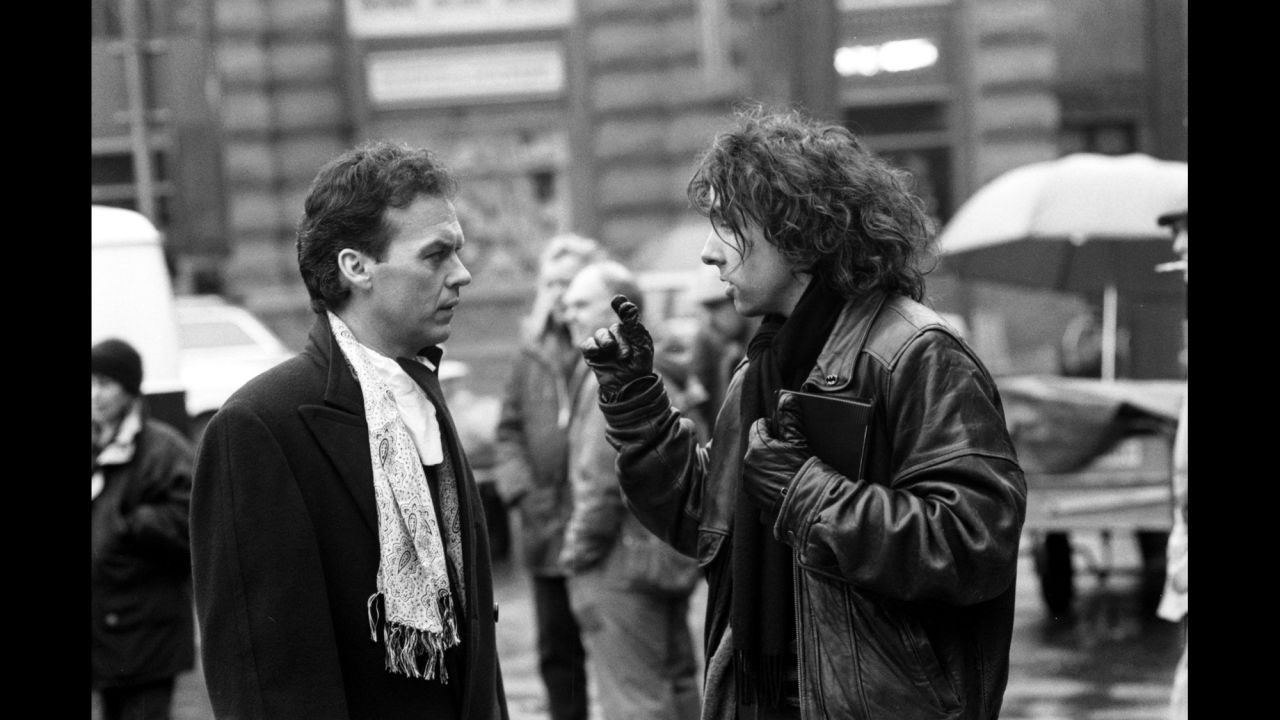Keaton, left, talks with director Tim Burton. The two had worked together just a year earlier on the dark comedy "Beetlejuice."