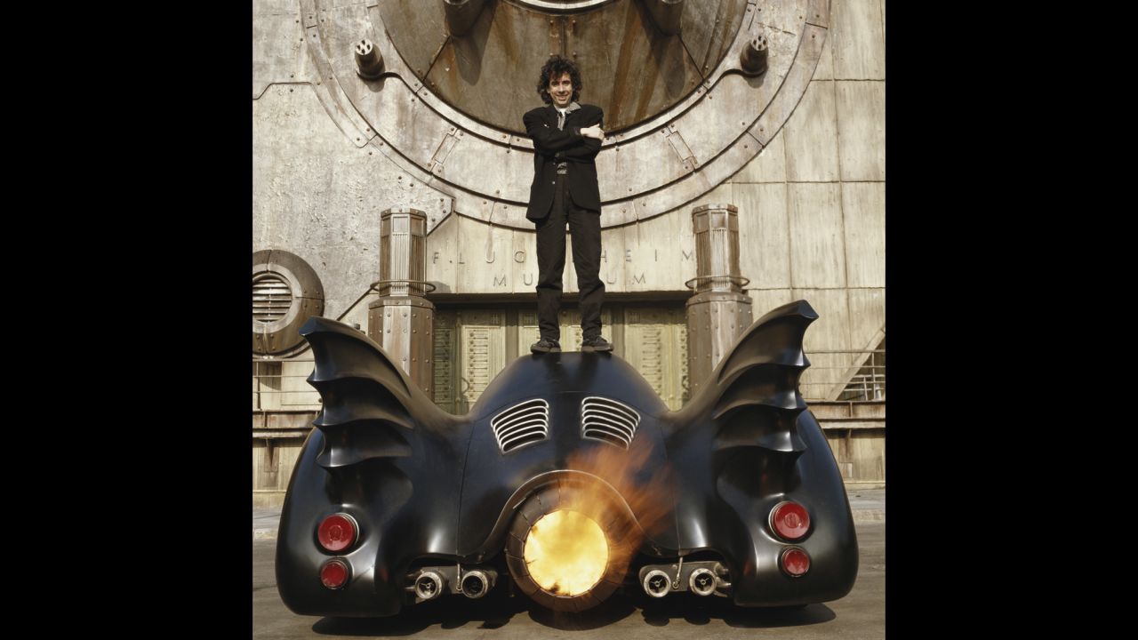 Burton stands on top of the Batmobile at Pinewood Studios in England.