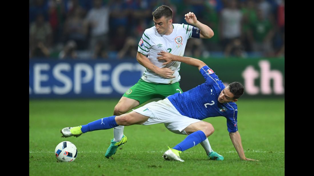 Ireland's Seamus Coleman, top, battles Italy's Mattia De Sciglio for possession of the ball.
