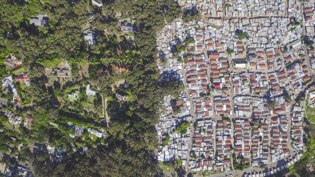 Hout Bay is the image that seems to resonate with South Africans the most, says Miller. "The red roofed houses are actually government houses. The tin shacks all around it are the informal settlements". 