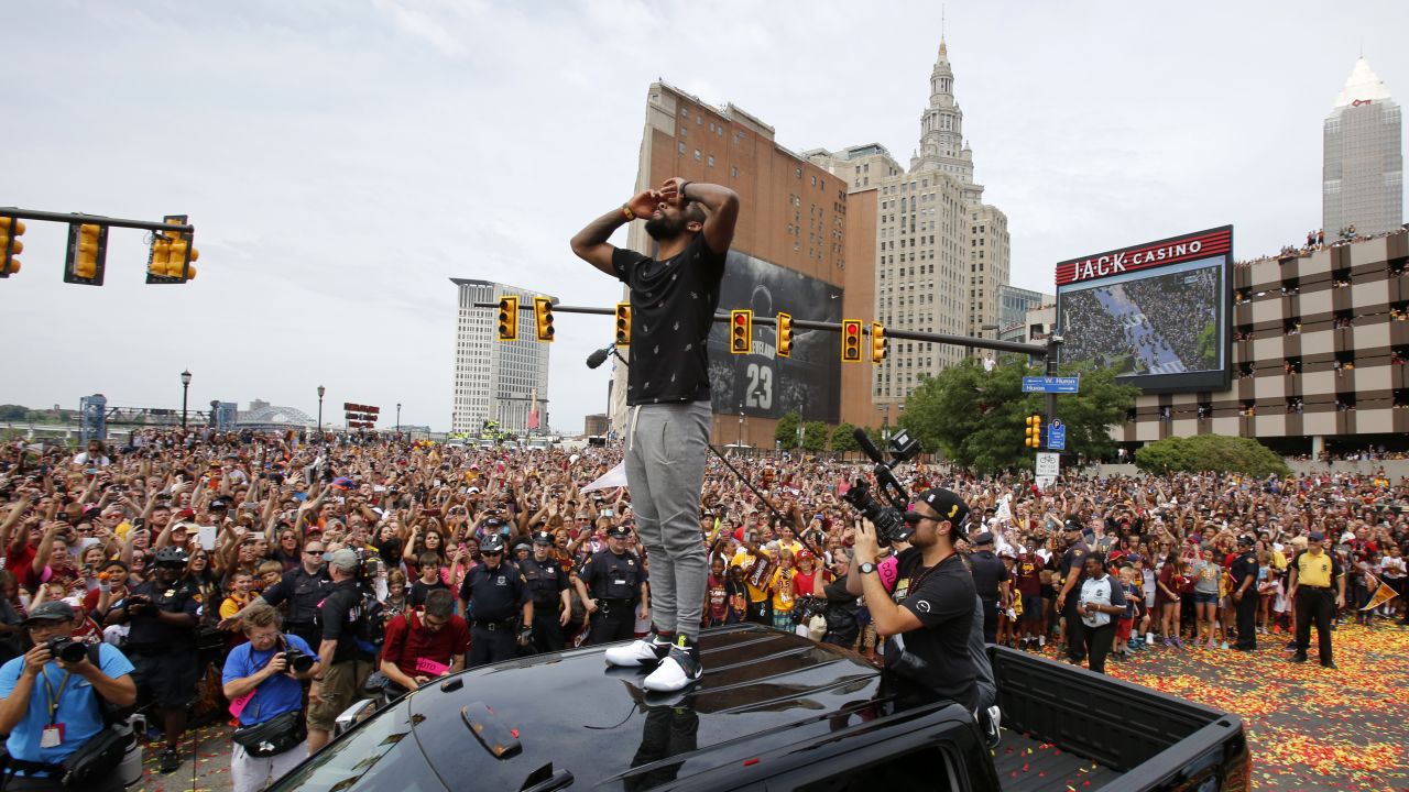 Cavaliers guard Kyrie Irving stands on the roof of a pickup truck to greet fans before the start of the parade.