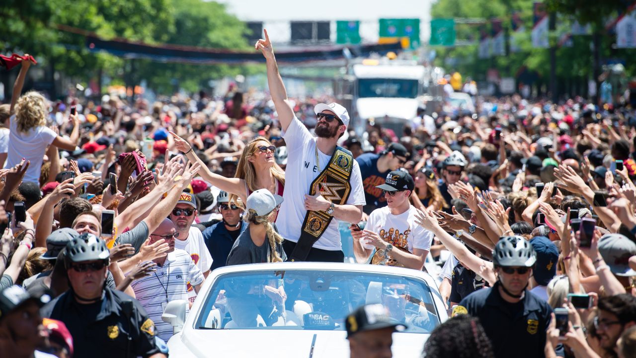 Cavaliers forward Kevin Love holds a pro-wrestling title belt during the parade.