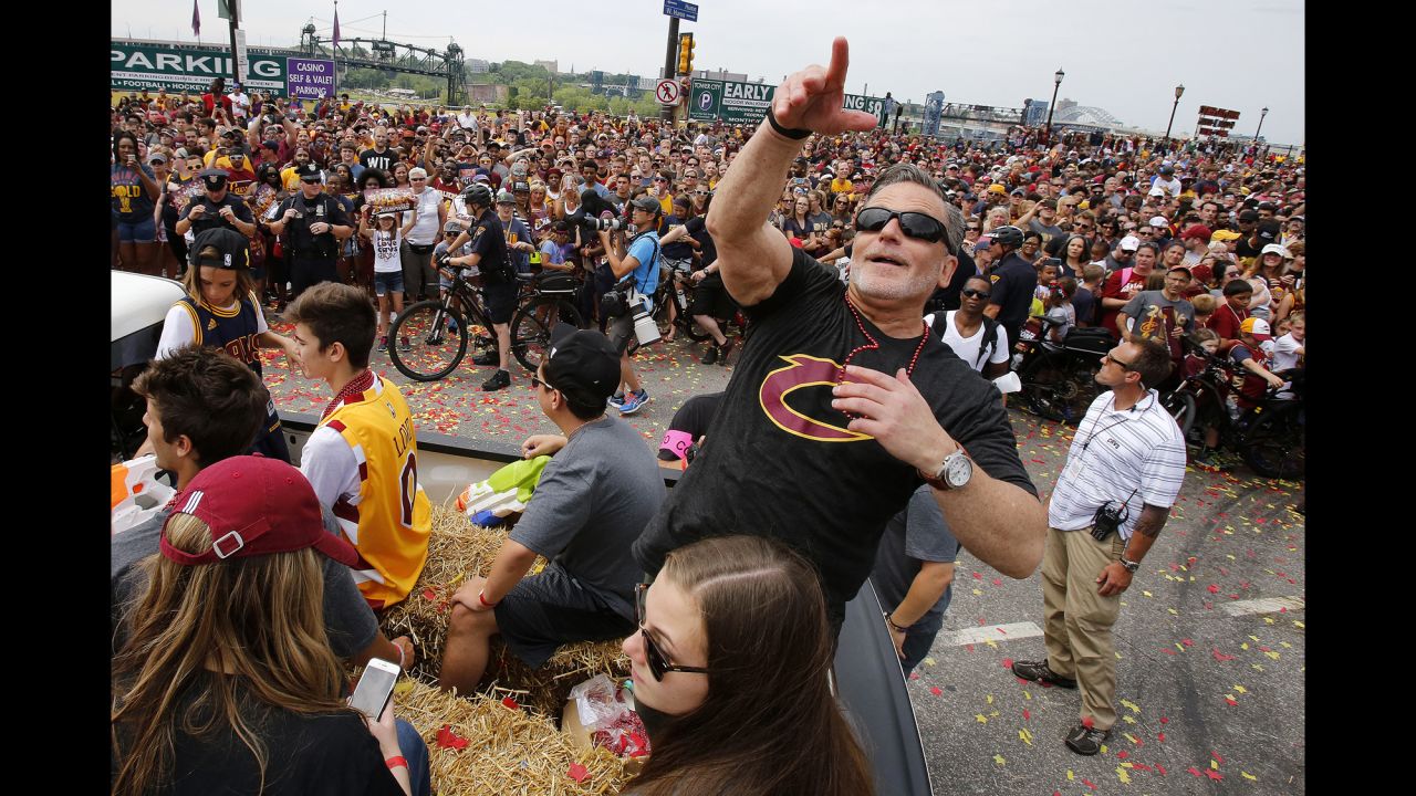 Team owner Dan Gilbert tosses beads into the crowd.
