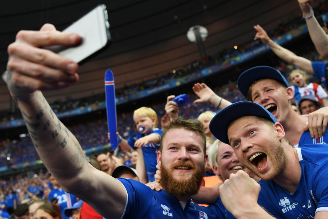  Aron Gunnarsson of Iceland takes a selfie photographs with Iceland fans.
