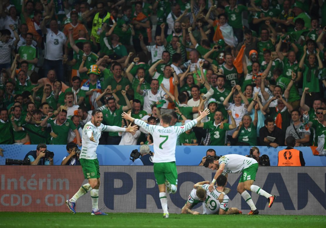 Ireland's players celebrate with supporters after Robbie Brady's late strike.