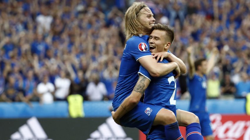 TOPSHOT - Iceland's midfielder Arnor Ingvi Traustason celebrates scoring the team's second goal with teammate Iceland's midfielder Birkir Bjarnason (top) during the Euro 2016 group F football match between Iceland and Austria at the Stade de France stadium in Saint-Denis, near Paris on June 22, 2016. / AFP / ODD ANDERSEN        (Photo credit should read ODD ANDERSEN/AFP/Getty Images)