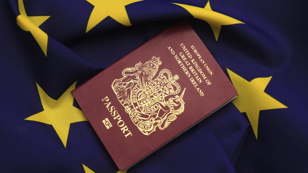 KNUTSFORD, UNITED KINGDOM - MARCH 17: In this photo illustration, a United Kingdom EU passport sits on a European Union flag on March 17, 2016 in Knutsford, United Kingdom. The United Kingdom will hold a referendum on June 23, 2016 to decide whether or not to remain a member of the European Union (EU), an economic and political partnership involving 28 European countries which allows members to trade together in a single market and free movement across its borders for citizens. (Photo by illustration by Christopher Furlong/Getty Images)
