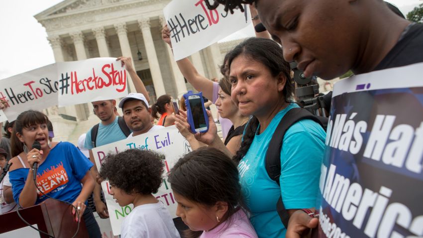 WASHINGTON, DC - JUNE 23: Families react to news on a Supreme Court decision blocking Obama's immigration plan, which would have protected millions of immigrants from deportation, in front of the U.S. Supreme Court, on June 23, 2016 in Washington, DC.  The court was divided 4-4, leaving in place an appeals court ruling blocking the plan. (Photo by Allison Shelley/Getty Images)