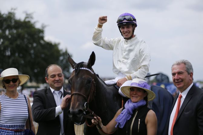 Italian jockey Cristian Demuro celebrates after coming first in the race on his horse La Cressonniere.