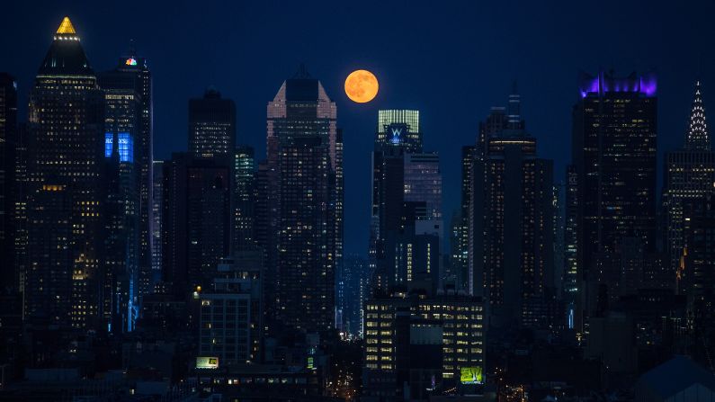 A full moon rises above skyscrapers in New York on Monday, June 20. The <a href="http://www.cnn.com/2016/06/20/health/summer-solstice-strawberry-moon-irpt/" target="_blank">"strawberry moon"</a> coincided with the summer solstice for the first time since 1967.