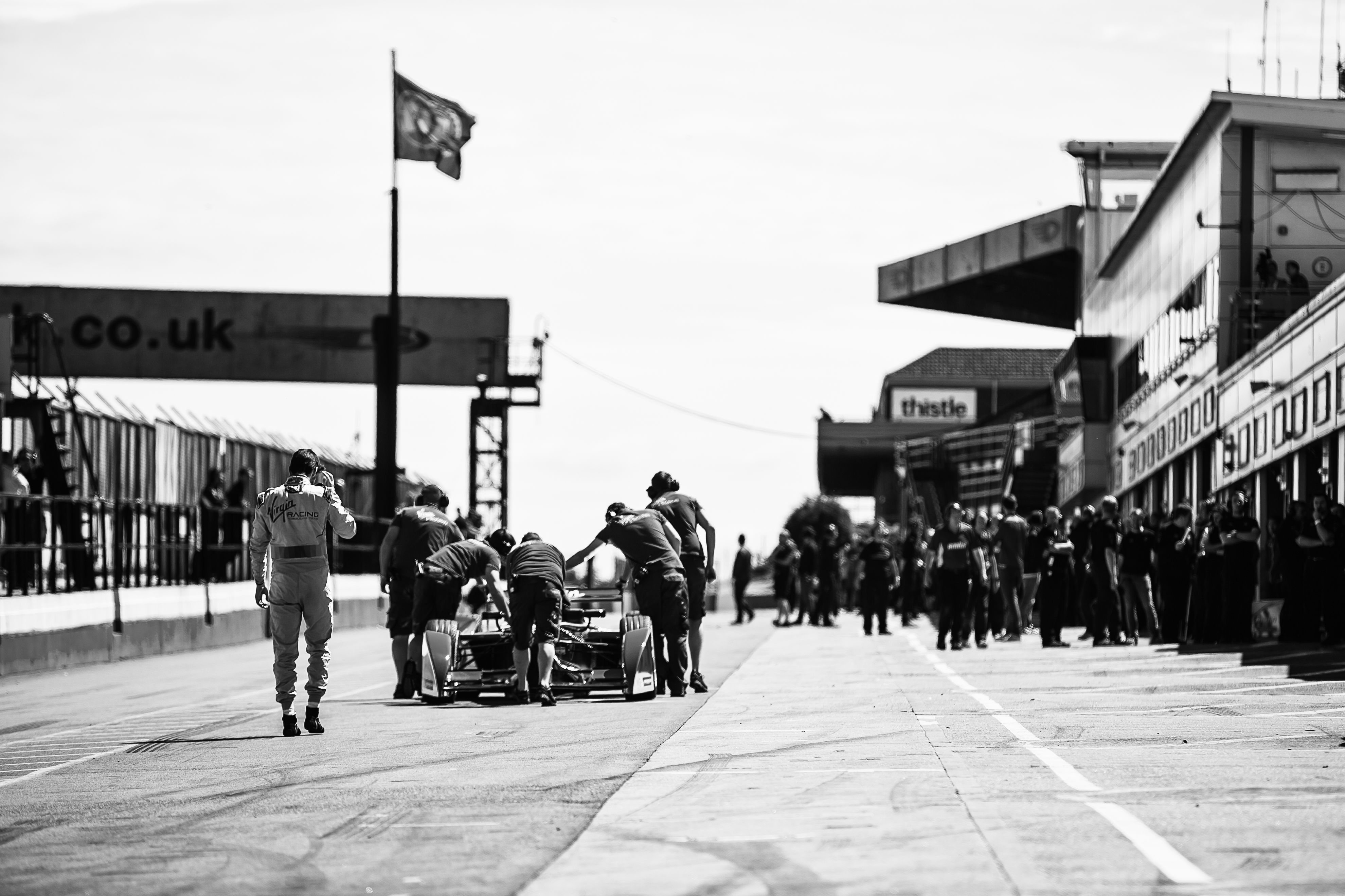 A Formula E car is wheeled back along the pit lane at the UK's Donnington Park circuit.