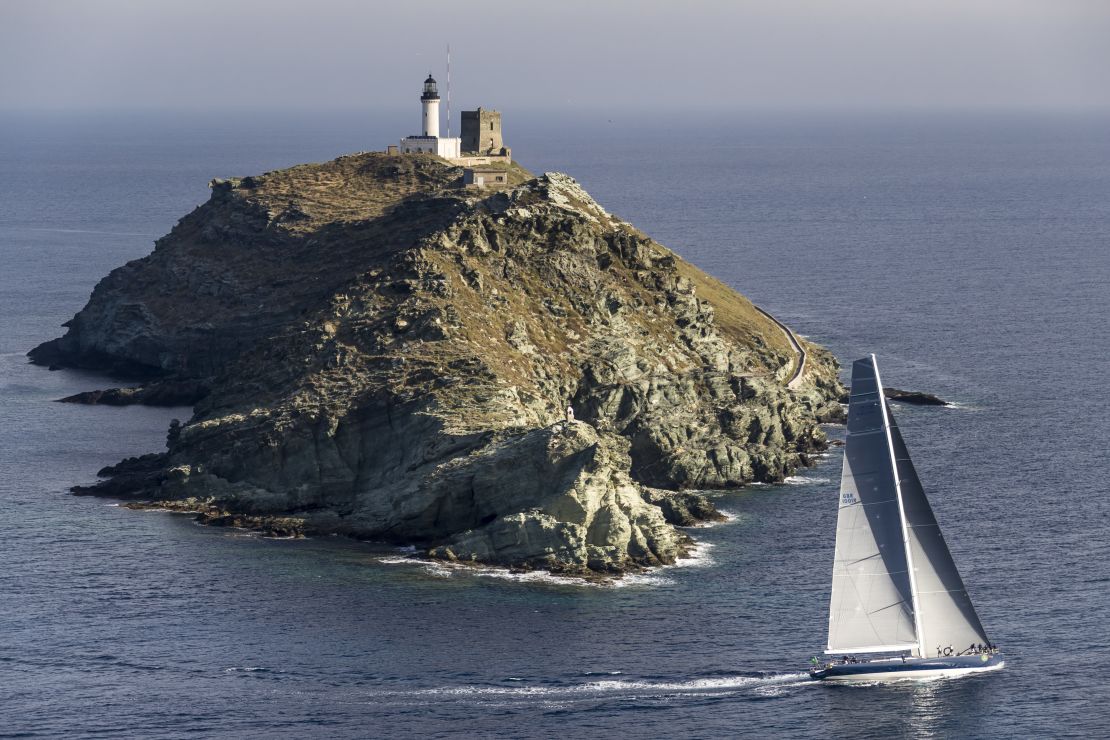 Magic Carpet, owned by Sir Lindsay Owen-Jones, rounds the Giraglia rock off Corsica's north coast.