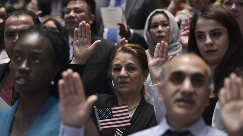 People take part in a naturalization ceremony in Washington on Monday, June 20.