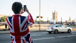 LONDON, ENGLAND - JUNE 24:  A vote LEAVE supporter takes a photo of Parliament from outside Vote Leave HQ, Westminster Tower on June 24, 2016 in London, England. The United Kingdom has gone to the polls to decide whether or not the country wishes to remain within the European Union. After a hard fought campaign from both REMAIN and LEAVE the vote is awaiting a final declaration and the United Kingdom is projected to have voted to LEAVE the European Union.   (Photo by Chris J Ratcliffe/Getty Images)