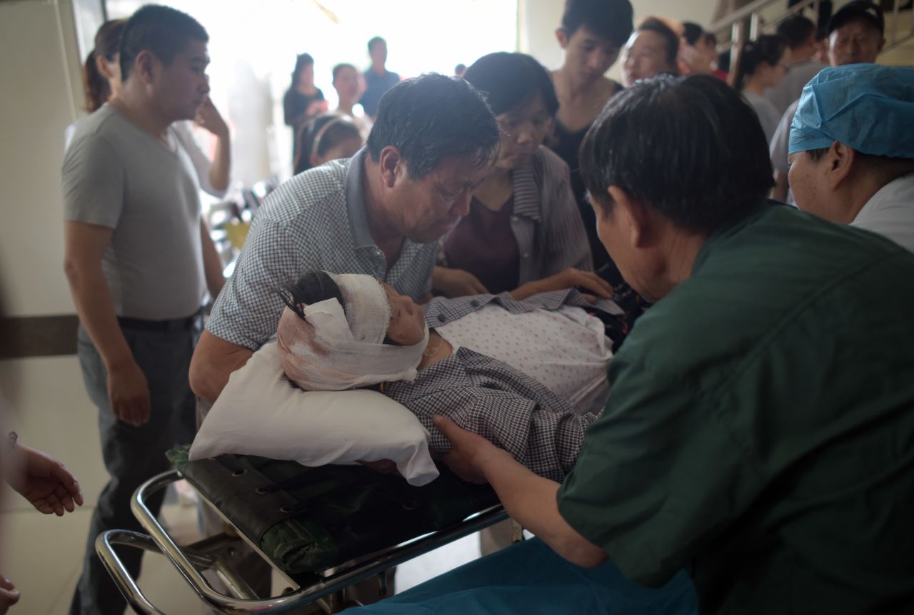 A victim with a head injury lies on a stretcher at the hospital in Funing on June 24.