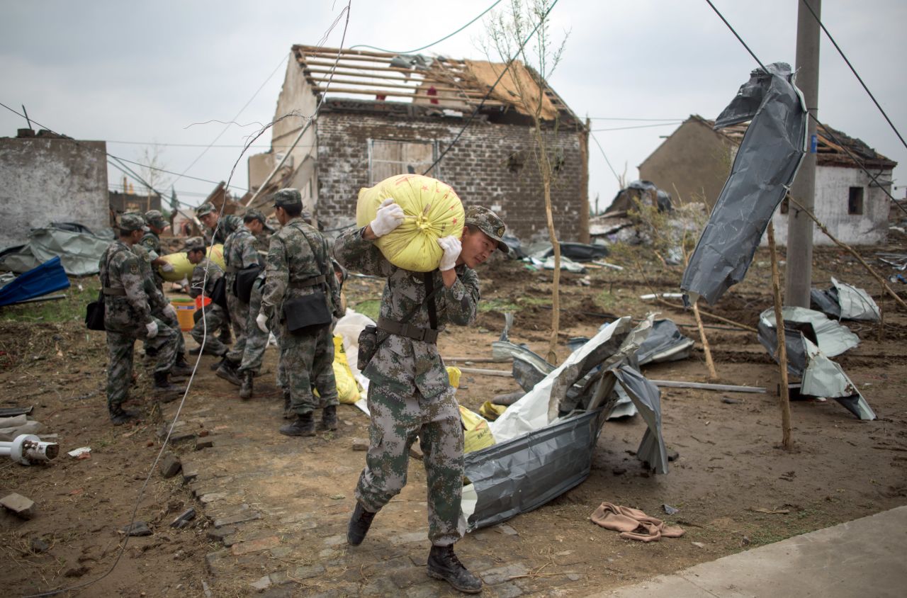 Soldiers work in the rubble of Funing on June 24. According to the Ministry of Civil Affairs, the central government in Beijing has sent a team to oversee disaster relief efforts.