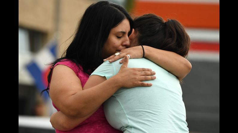 Family members of Travis Mason console each other as they place flowers outside the marijuana dispensary where he worked in Aurora, Colorado, on Monday, June 20. Mason, a 24-year-old Marine Corps veteran, was providing security at the dispensary <a href="index.php?page=&url=http%3A%2F%2Fwww.denverpost.com%2F2016%2F06%2F20%2Fgreen-heart-marijuana-dispensary-security-guard-killed%2F" target="_blank" target="_blank">when he was shot and killed</a> during an attempted robbery.