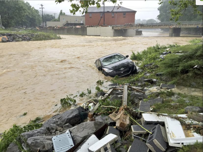 A vehicle is washed away in White Sulphur Springs on June 24.