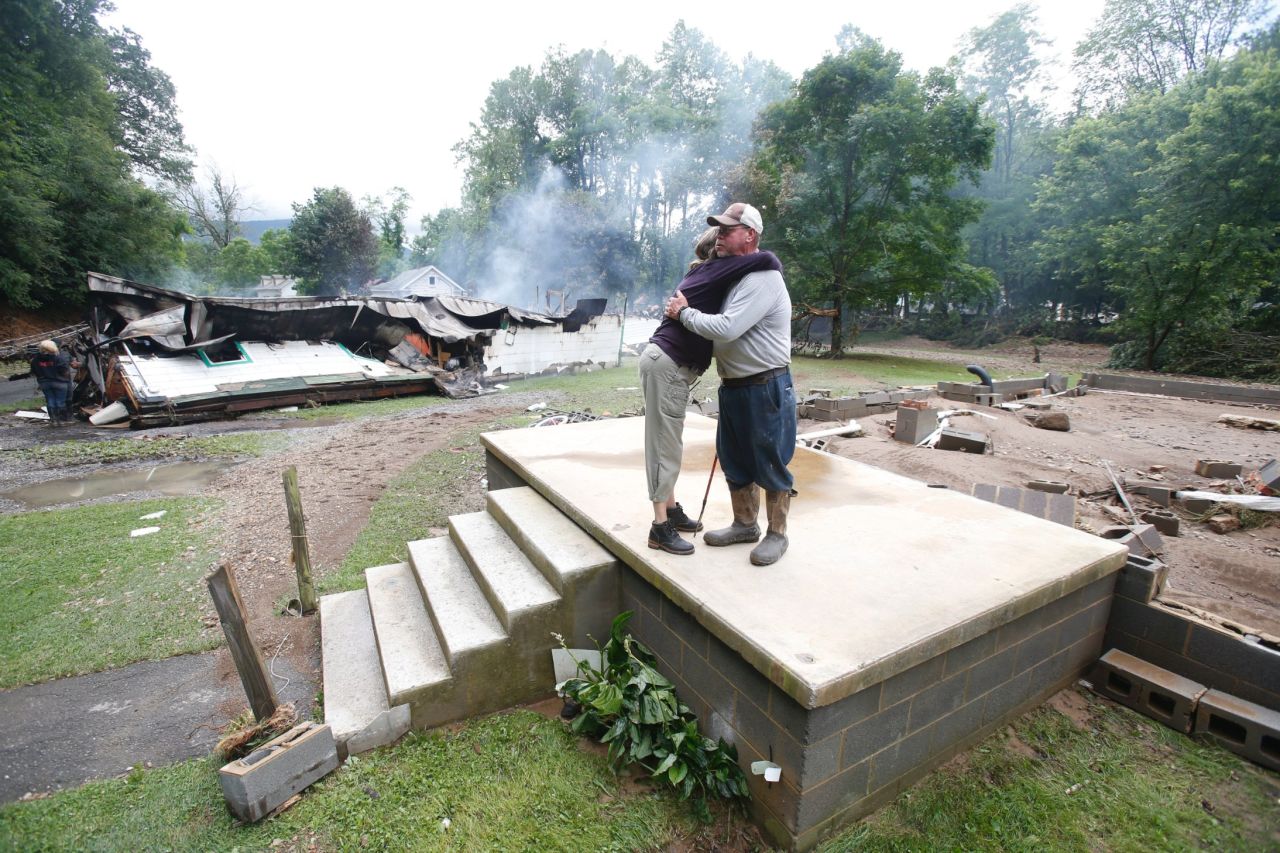 Jimmy Scott gets a hug from Anna May Watson as they clean up in White Sulphur Springs on June 24.