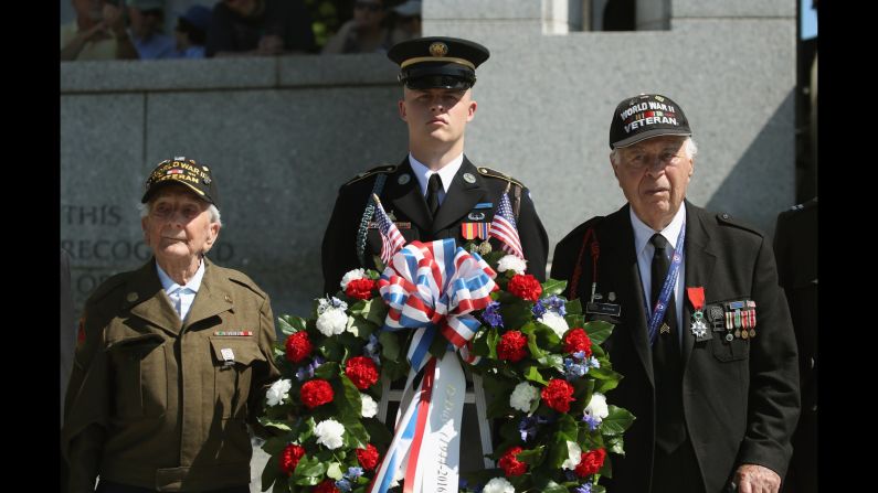 D-Day veterans George Krakosky, left, and Herman Zeitchik, right, attend a wreath-laying ceremony at the National World War II Memorial on Monday, June 6. D-Day was the largest amphibious invasion in history. On June 6, 1944, more than 160,000 Allied troops -- about half of them Americans -- <a href="index.php?page=&url=http%3A%2F%2Fwww.cnn.com%2F2012%2F06%2F05%2Fworld%2Fgallery%2Fd-day%2Findex.html" target="_blank">invaded Western Europe,</a> overwhelming German forces in an operation that proved to be a turning point in World War II.
