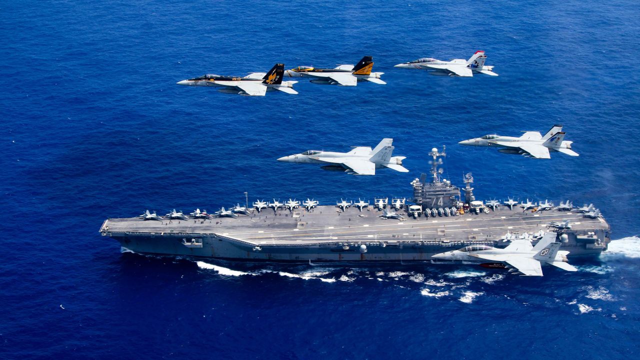 <strong>F/A-18 Hornets fly above the Nimitz-class aircraft carrier USS John C. Stennis in the Pacific Ocean. The US Navy has 10 of the 97,000-ton ships, which can carry more than 60 aircraft each.</strong>