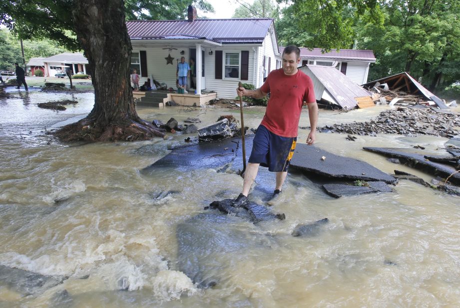 Mark Bowes makes his way to a road after severe flooding in White Sulphur Springs on June 24. 