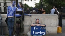 LONDON, ENGLAND- JUNE 24: A young couple painted as EU flags protest on outside Downing Street against the United Kingdom's decision to leave the EU following the referendum on June 24, 2016 in London, United Kingdom. The United Kingdom has gone to the polls to decide whether or not the country wishes to remain within the European Union. After a hard fought campaign from both REMAIN and LEAVE the vote is too close to call. A result on the referendum is expected on Friday morning.  (Photo by Mary Turner/Getty Images)