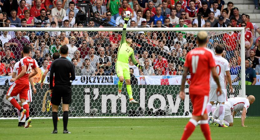 Poland goalkeeper Lukasz Fabianski, center, makes a save.