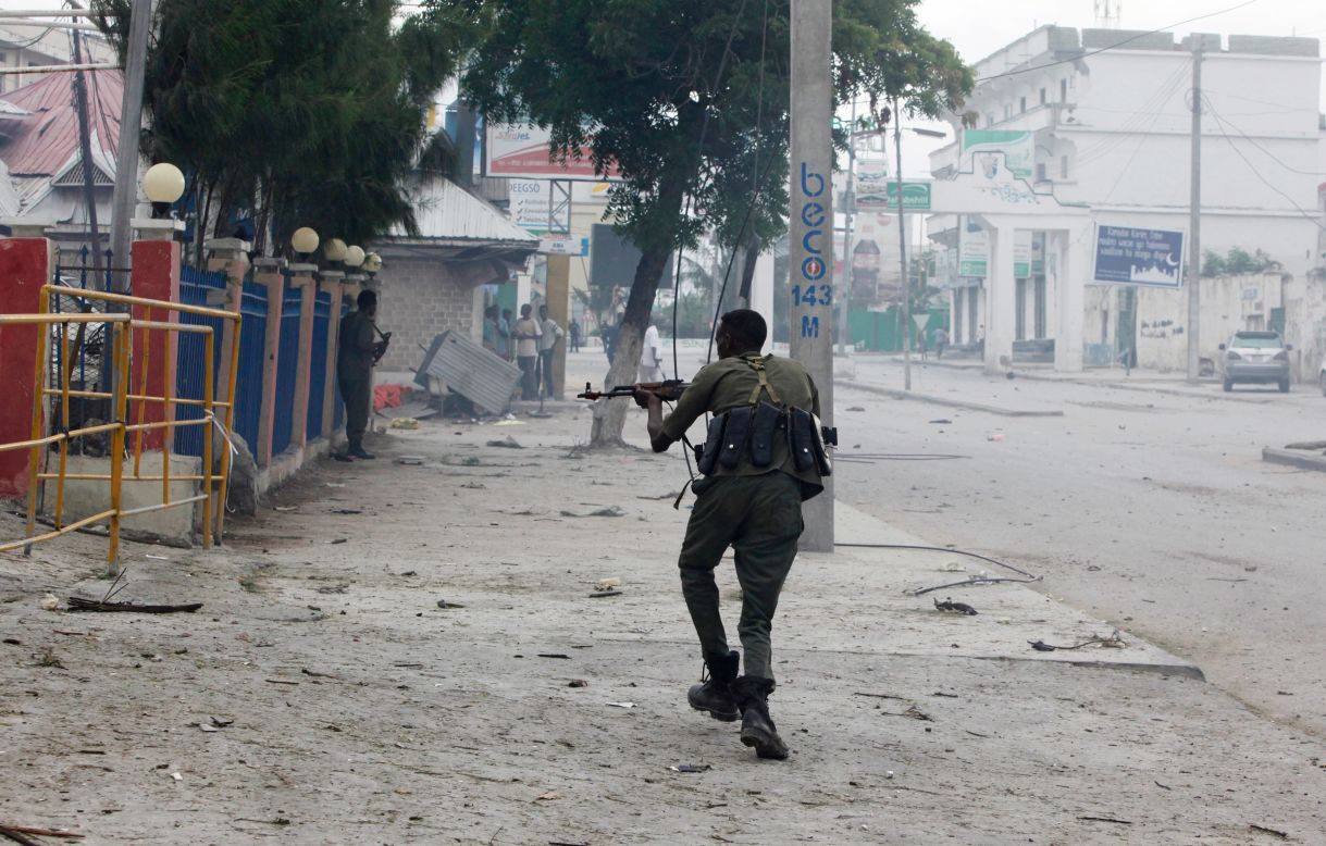 A Somali soldier takes position on the street near the scene of the attack, which comes three weeks after suspected Al-Shabaab gunmen <a href="http://www.cnn.com/2016/06/01/africa/somalia-mogadishu-ambassador-hotel-siege/" target="_blank">set off an explosion</a> and stormed another popular Mogadishu hotel, killing at least 13 people, according to security officials. Three attackers were also killed.