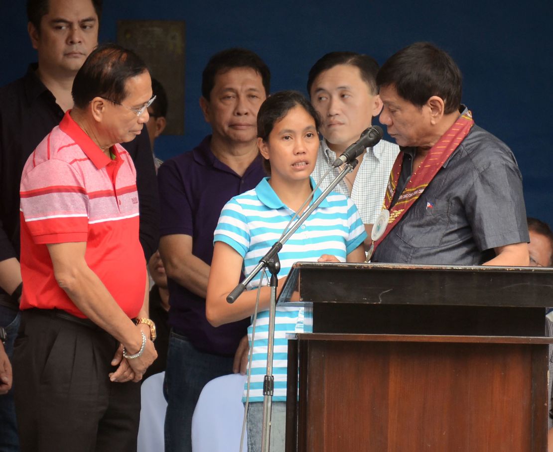 Duterte talks to released hostage Marites Flor on stage, June 24, 2016. 