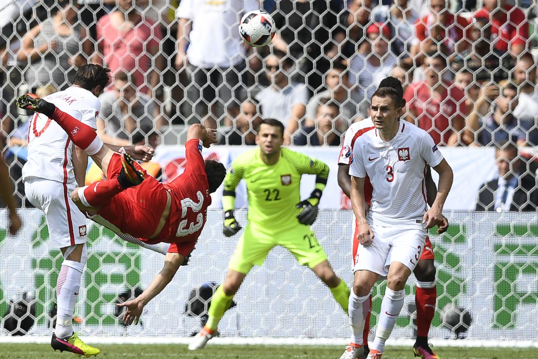 Switzerland's midfielder Xherdan Shaqiri scores with a spectacular overhead kick as his team drew level 1-1 with Poland in their Euro 2016 last 16 tie. 