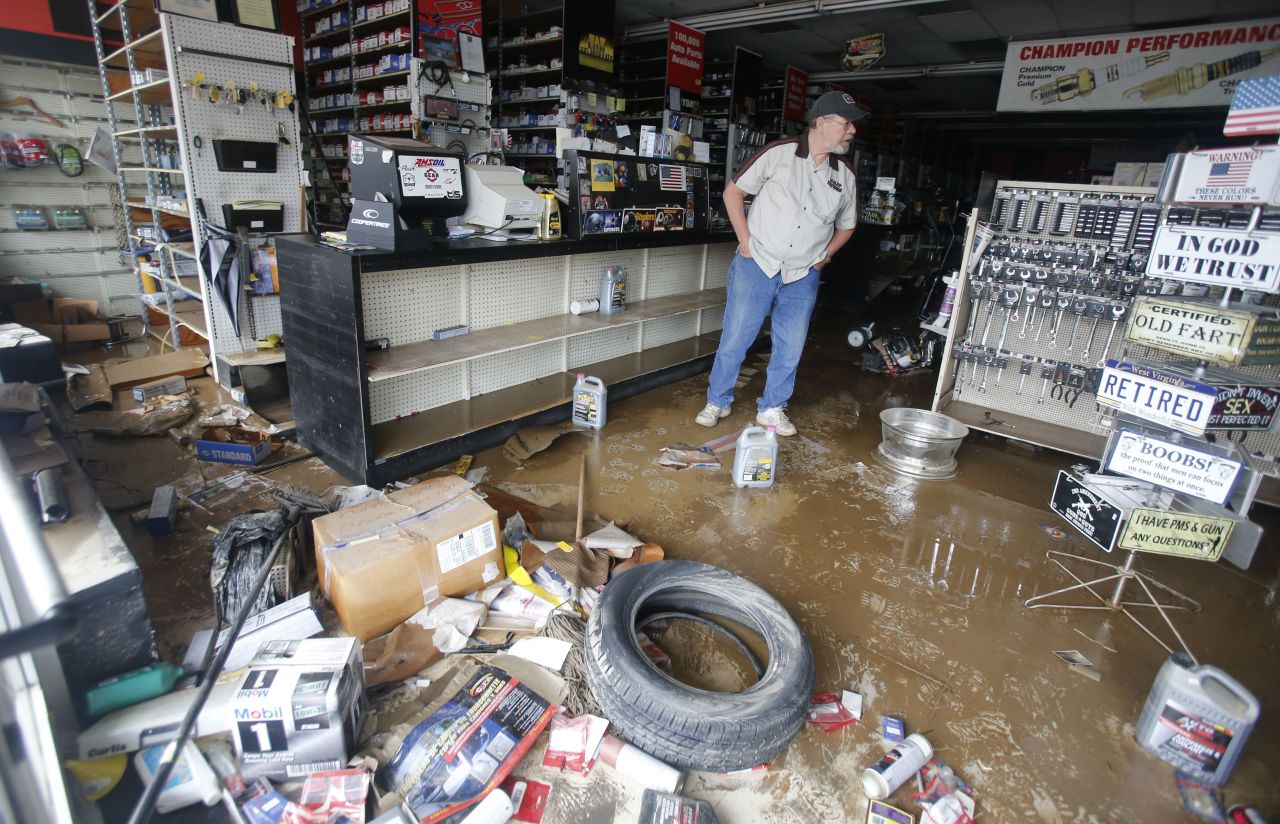 Paul Raines looks over his flooded Western Auto store in Rainelle on June 25. 