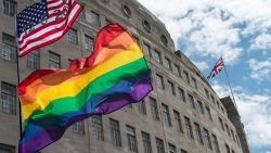 LONDON, ENGLAND - JUNE 25:  An American flag with the date of the Orlando shotings flies next to rainbow flags and a Union Jack behind as the LGBT community celebrates Pride in London on June 25, 2016 in London, England. Across the city performances and speeches take place as a parade makes it way through the centre ending in Trafalgar Square. 2016 Pride in London comes just two weeks after Omar Mateen shot dead 50 people at Pulse, a gay nightclub in Orlando, Florida.  (Photo by Chris J Ratcliffe/Getty Images)