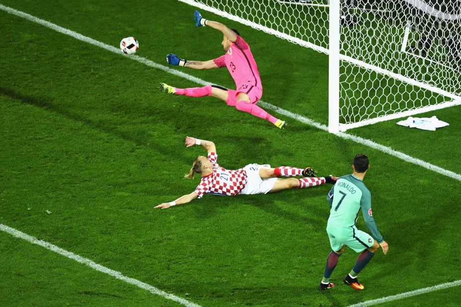 Cristiano Ronaldo, right, of Portugal shoots for a goal, but Croatia's Danijel Subasic makes the save. 