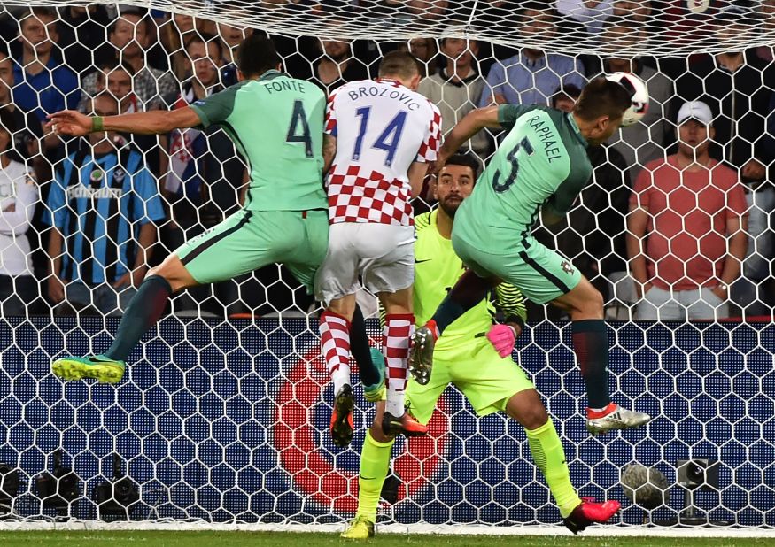 Croatia midfielder Marcelo Brozovic, second left, vies with Portugal defenders Jose Fonte, left, and Raphael Guerreiro, right, in front of Portugal goalkeeper Rui Patricio.