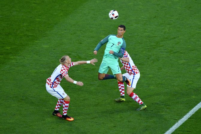 Cristiano Ronaldo, center, of Portugal heads the ball under pressure of Domagoj Vida, left, and Ivan Strinic, right, of Croatia.