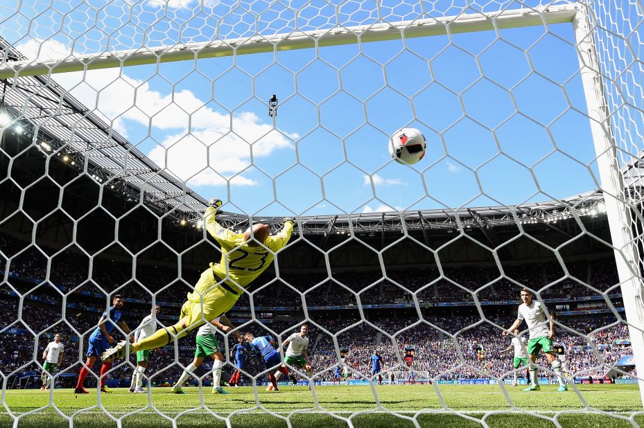 Darren Randolph of Ireland dives in vain as Antoine Griezmann, center, of France scores his team's second goal.