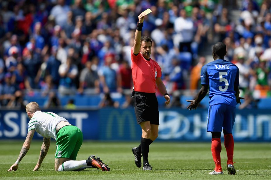 N'Golo Kante of France is shown a yellow card by referee Nicola Rizzoli after fouling James McClean of Ireland.