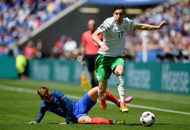 Stephen Ward of Ireland is tackled by Antoine Griezmann of France.
