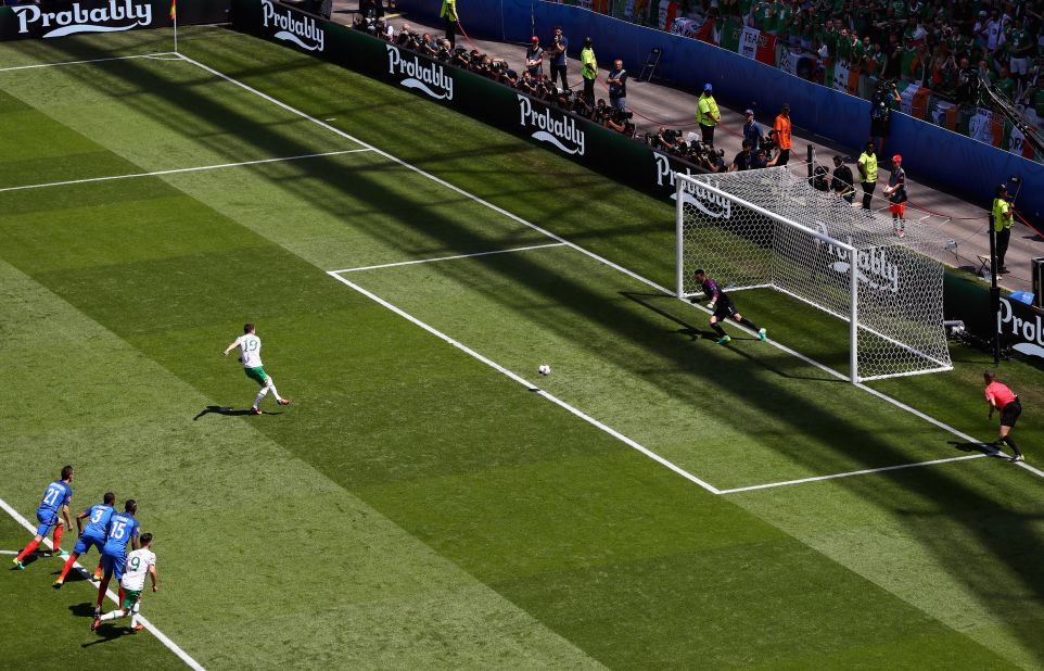 Robbie Brady of Ireland converts a penalty to score the opening goal past Hugo Lloris of France.