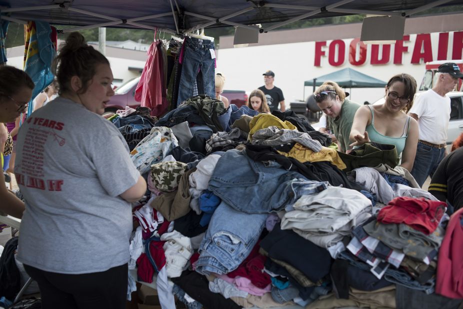 People in Clendenin look through personal items that were brought in as part of a local relief effort on June 25.