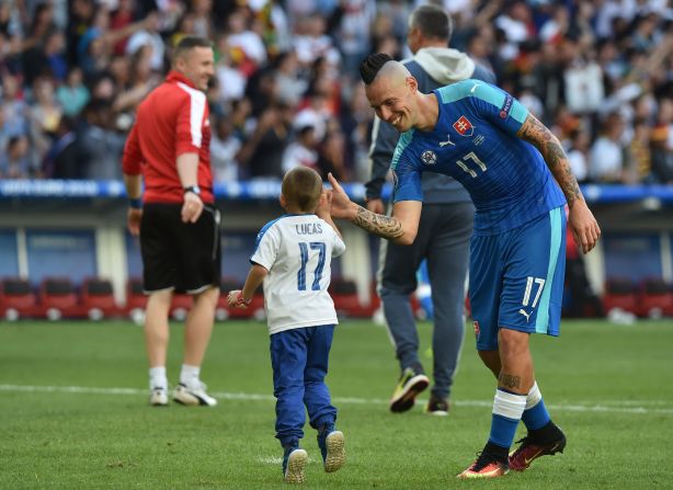 Slovakia midfielder Marek Hamsik shakes hands with his son after the game. 