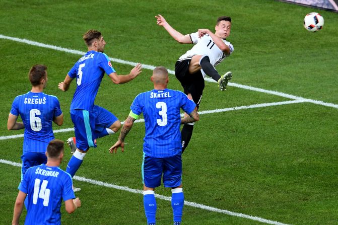 Julian Draxler, right, of Germany scores his team's third goal.