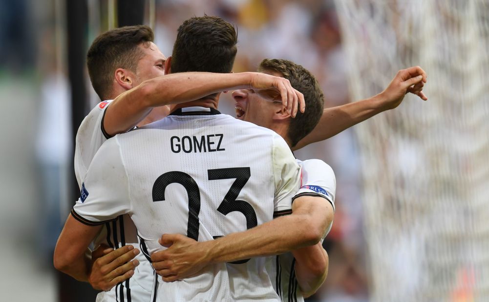 Germany's forward Mario Gomez, center, celebrates with midfielder Julian Draxler and midfielder Thomas Mueller, right, after scoring.